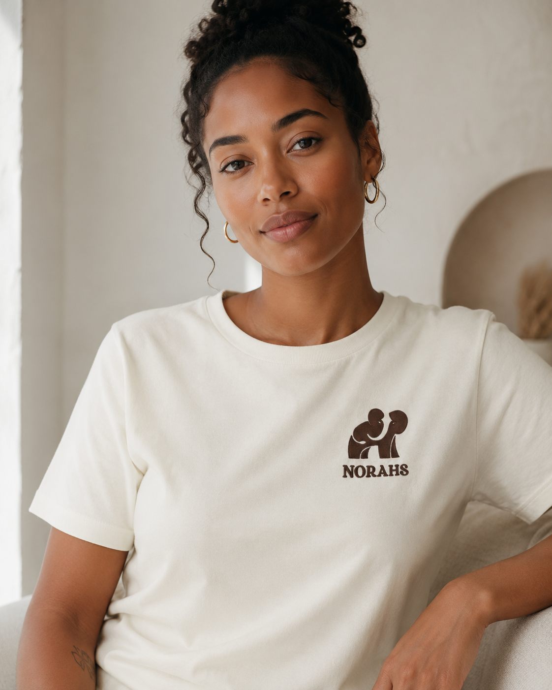 Younger Woman wearing the natural Signature Supima Tee, front view
