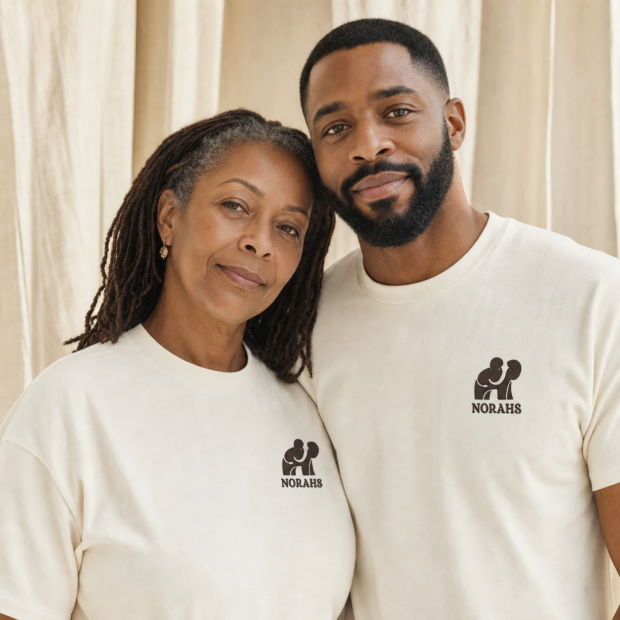 Black mother and adult son wearing natural Norahs shirts